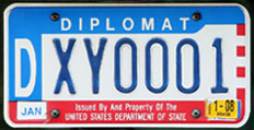 1984 base OFM Diplomat license plate, late embossed style, no. DXY0001
