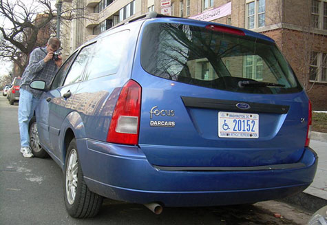 Photographing a windshield sticker near Scott Circle in March 2007