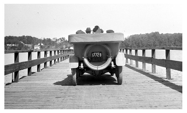 Michigan touring car crossing a wooden bridge in Sept. 1913.