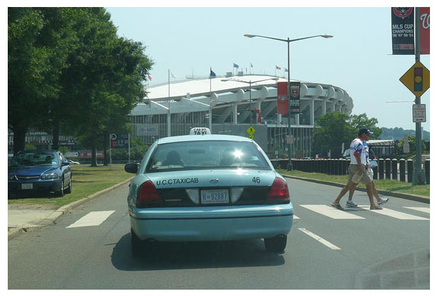 Taxi approaching RFK Stadium eastbound on E. Capitol St.