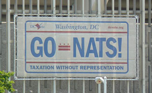 Image of GO-NATS banner in a license plate theme on the side of RFK Stadium